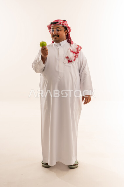 Overweight Saudi Man with Green Apple in Studio