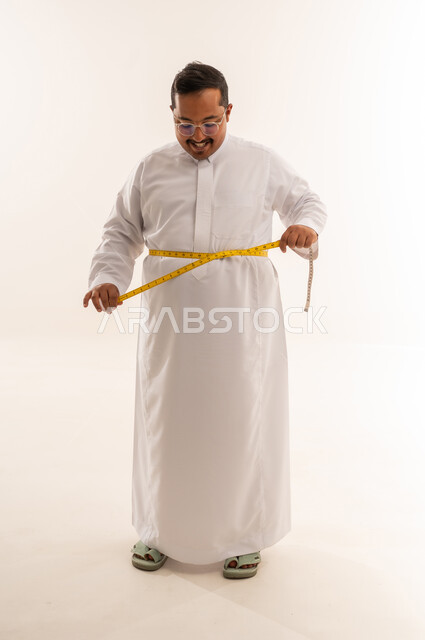 رجل سعودي يقيس محيط خصره في استوديو