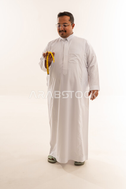 Overweight Saudi Man with Measuring Tape on White Background