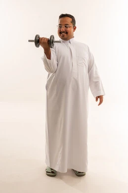 Saudi Man in Traditional Thobe Lifting Dumbbell
