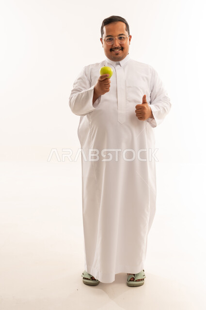 Smiling Overweight Saudi Man with Apple Thumbs Up