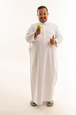 Smiling Overweight Saudi Man with Apple Thumbs Up