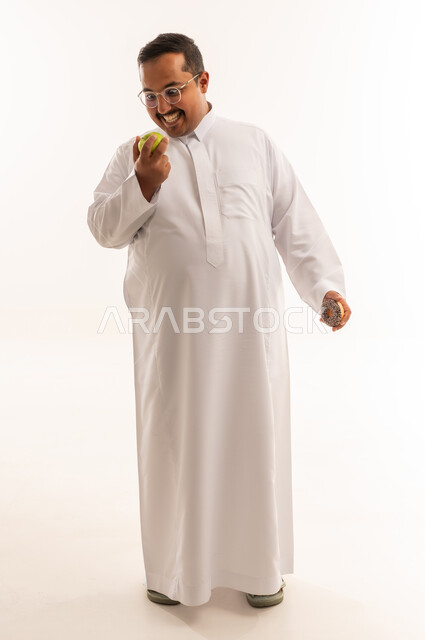 Overweight Saudi Man Choosing Between Apple and Doughnut