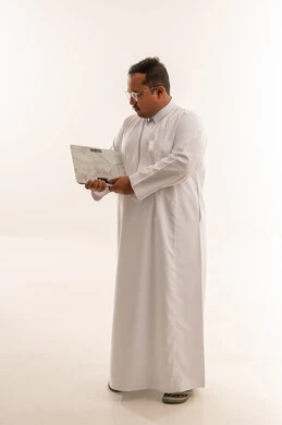 Overweight Saudi Man Holding Weight Scale in Studio