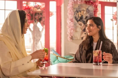 Arab Women in Traditional Abayas at a Cafe