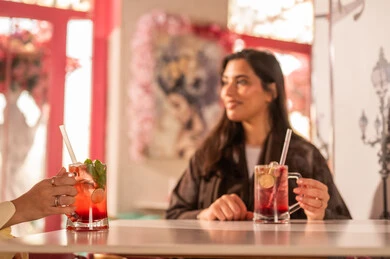 Saudi Woman in Abaya at Cafe with Cold Drink