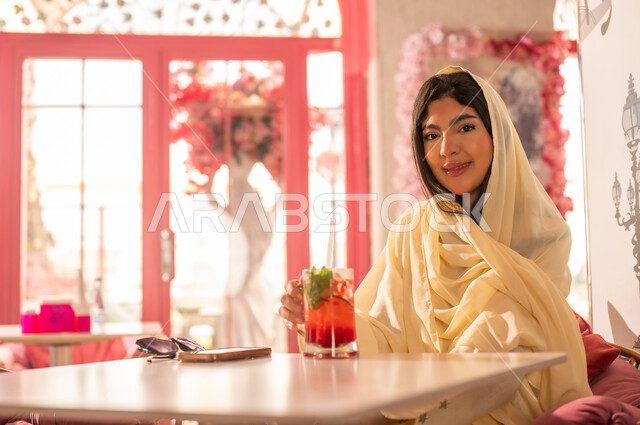 Saudi Woman in Traditional Abaya at Pink Cafe
