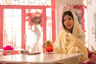 Saudi Woman in Traditional Abaya at Pink Cafe