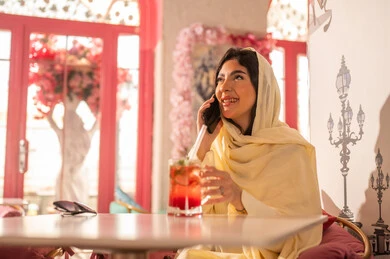 Arab Woman in Hijab Talking on Phone in Cafe