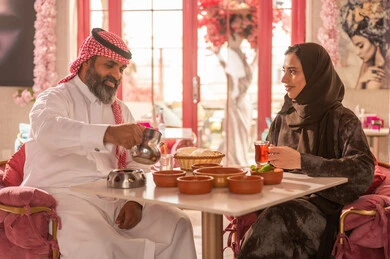 Saudi Couple in Traditional Dress Dining at Restaurant