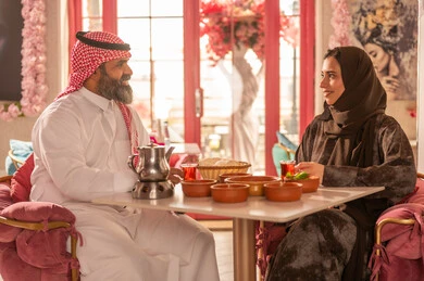 Saudi Couple in Traditional Attire Dining at Restaurant