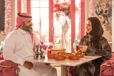 Saudi Couple in Traditional Attire Dining at Restaurant
