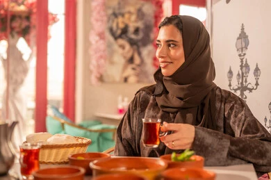 Saudi Woman in Abaya Drinking Tea at Restaurant