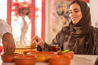 Saudi Woman Eating Traditional Falafel at Restaurant