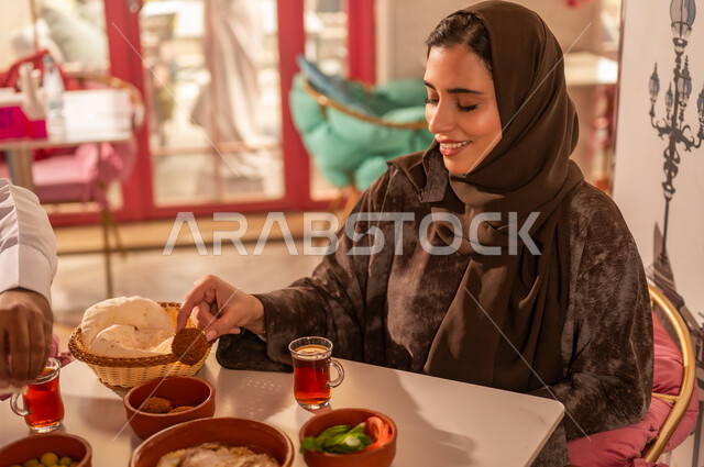 Saudi Woman Eating Traditional Breakfast in Restaurant