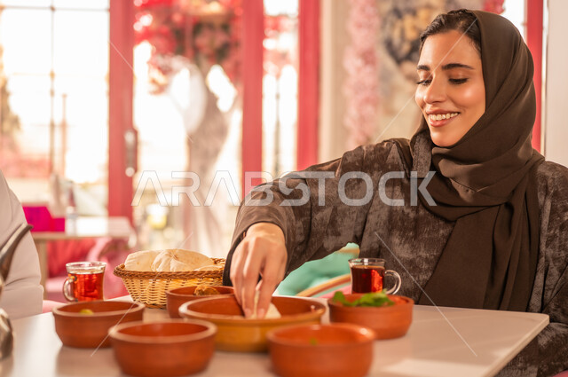 Saudi Woman Eating Traditional Breakfast in Restaurant