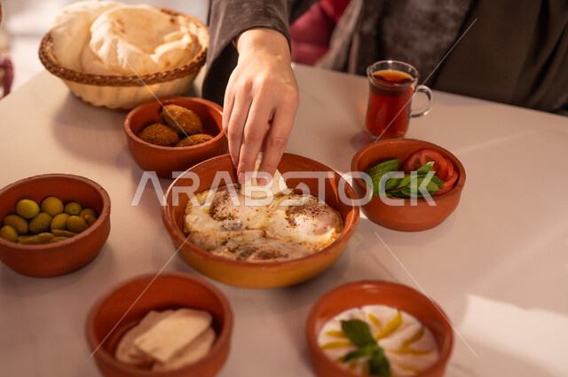 Arabic Woman Eating Traditional Breakfast with Tea