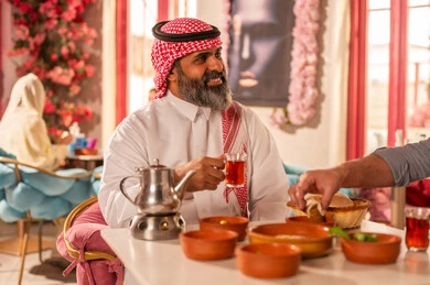 Saudi Man in Traditional Dress Having Arabic Breakfast