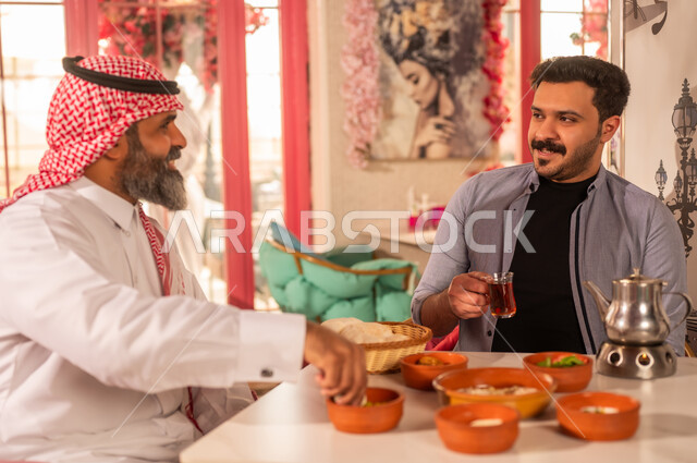 Saudi Men Having Traditional Breakfast in Restaurant