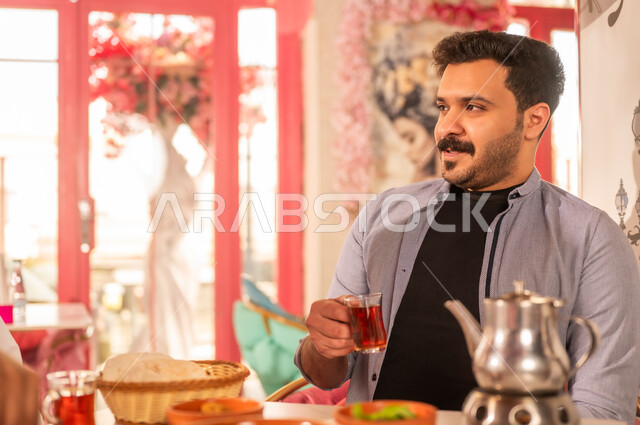 Saudi Man Drinking Traditional Tea in Restaurant