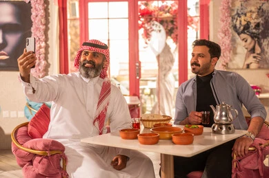 Saudi Men Taking Selfie at Restaurant with Traditional Food