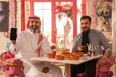 Saudi Men in Restaurant with Smartphone and Traditional Food