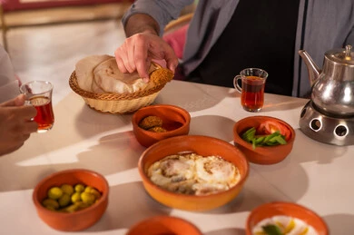 Man Eating Traditional Arabic Breakfast with Tea