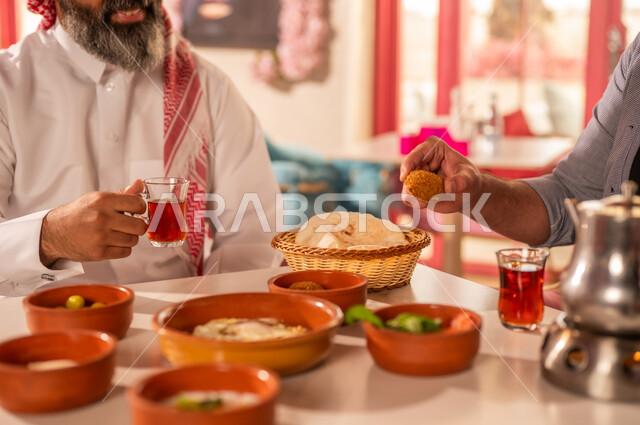 Saudi Man Eating Traditional Arabic Breakfast with Tea