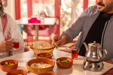 Saudi Men Having Traditional Arabic Breakfast Outdoors