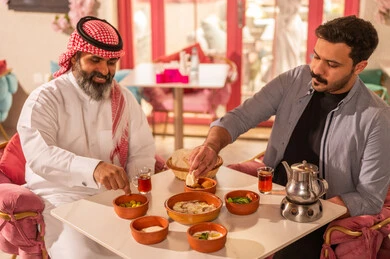 Saudi Men Having Traditional Breakfast in Restaurant