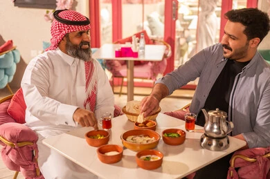 Saudi Men Eating Traditional Breakfast in Restaurant