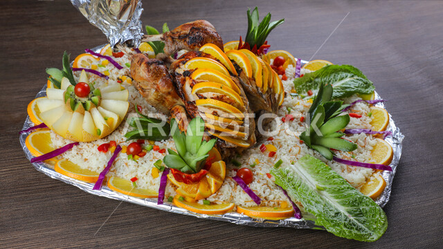 A plate of delicious grilled chicken and rice decorated with vegetables, Arabic meals, delicious recipes and dishes, delicious meals, Saudi Arabian Gulf restaurants