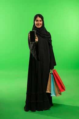 Saudi Woman with Smartphone and Shopping Bags on Green Screen