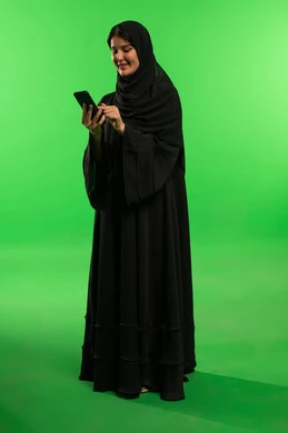Saudi Woman Using Smartphone on Green Screen Background