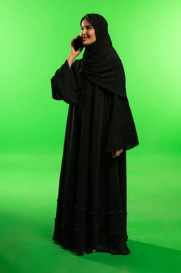 Saudi Woman in Abaya on Phone with Green Screen