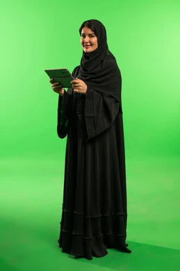 Saudi Woman Using Tablet on Green Screen Background