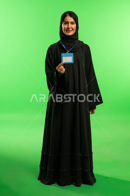 Saudi Woman in Abaya Holding ID Card on Green Screen