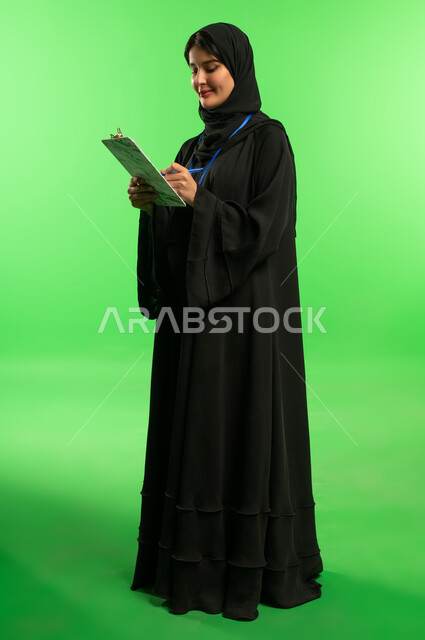 Saudi Woman with Clipboard on Green Screen Background