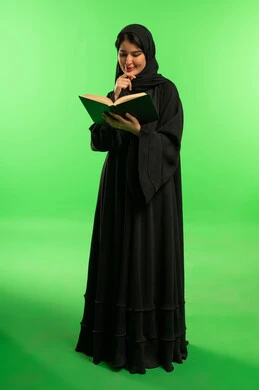 Saudi Woman in Abaya Reading Book on Green Screen