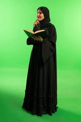 Saudi Woman Reading Book on Green Screen Background
