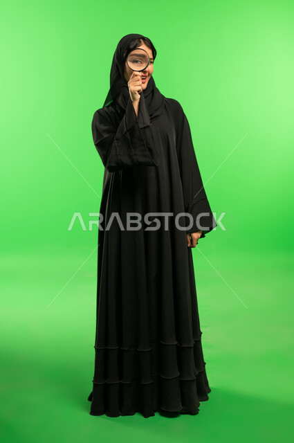 Saudi Woman with Magnifying Glass on Green Screen