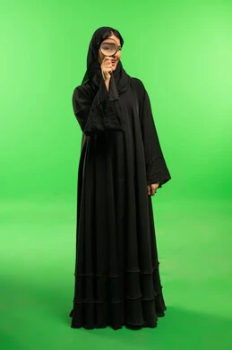 Saudi Woman with Magnifying Glass on Green Screen