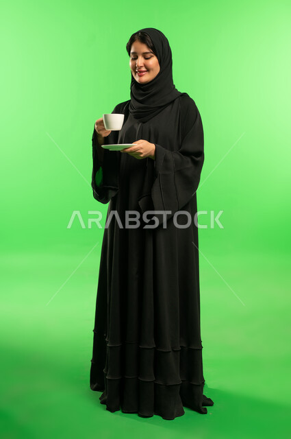 Saudi Woman in Abaya Holding Coffee Green Screen