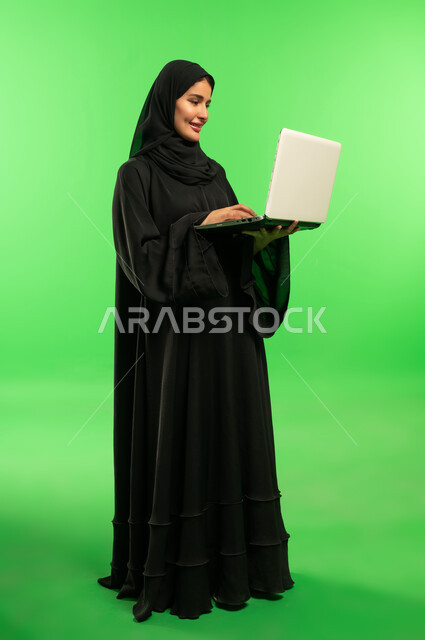 Saudi Woman with Laptop on Green Screen Background