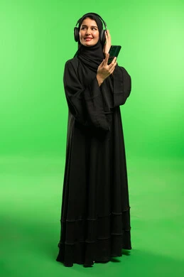 Saudi Woman with Headphones and Smartphone on Green Screen