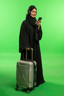 Saudi Woman with Suitcase and Phone on Green Screen