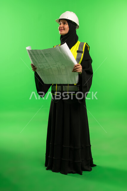 Saudi Female Engineer with Blueprints on Green Screen