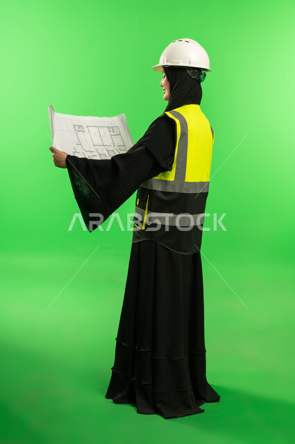 Saudi Female Engineer with Blueprint on Green Screen
