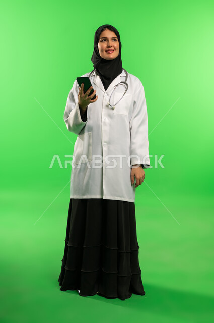 Saudi Female Doctor with Smartphone on Green Screen
