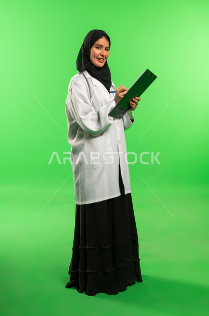 Saudi Female Doctor with Clipboard on Green Screen